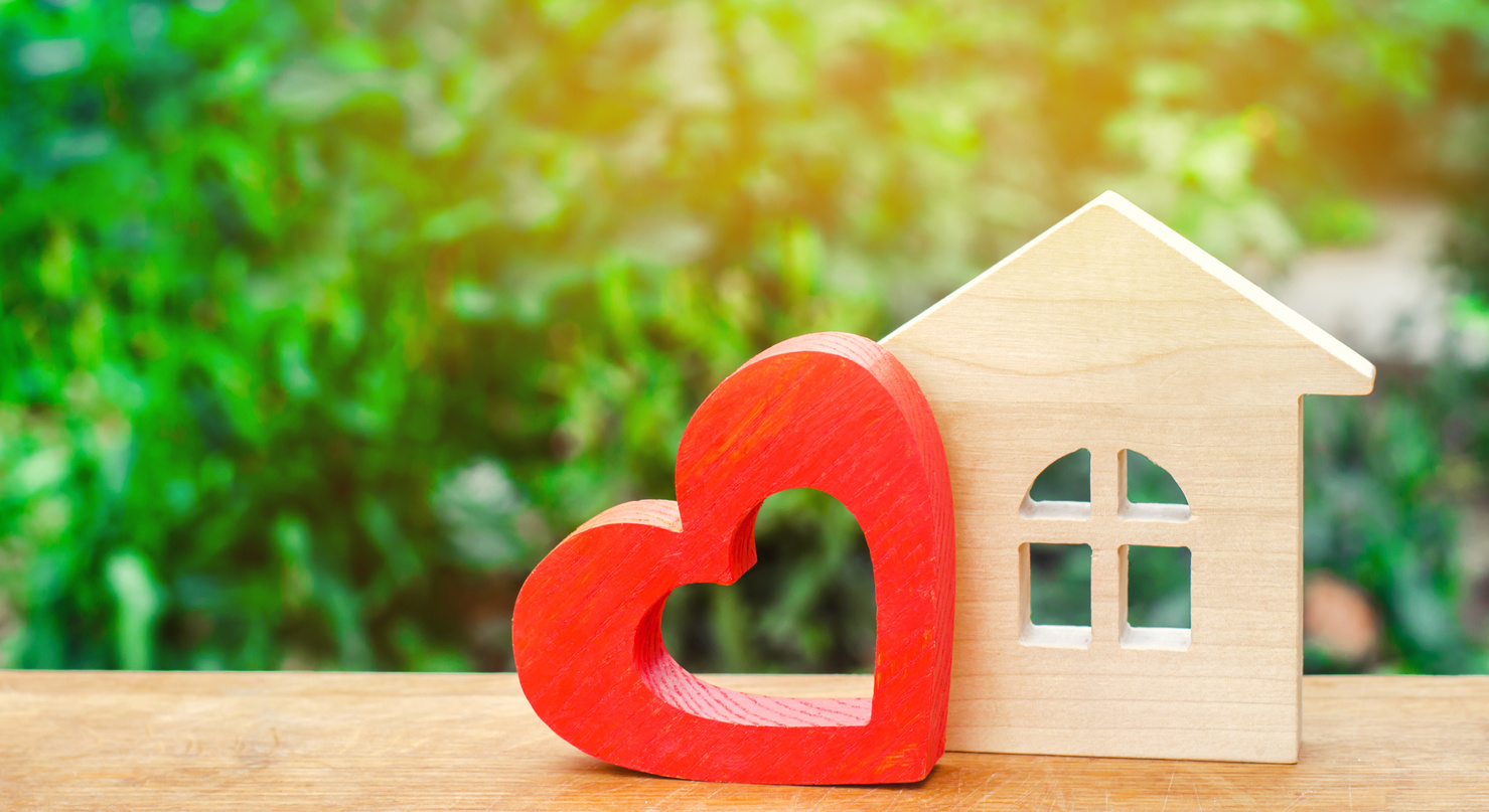 House with a red wooden heart. House of lovers. Affordable housing for young families. Valentine's day house. "Home Sweet Home". life insurance